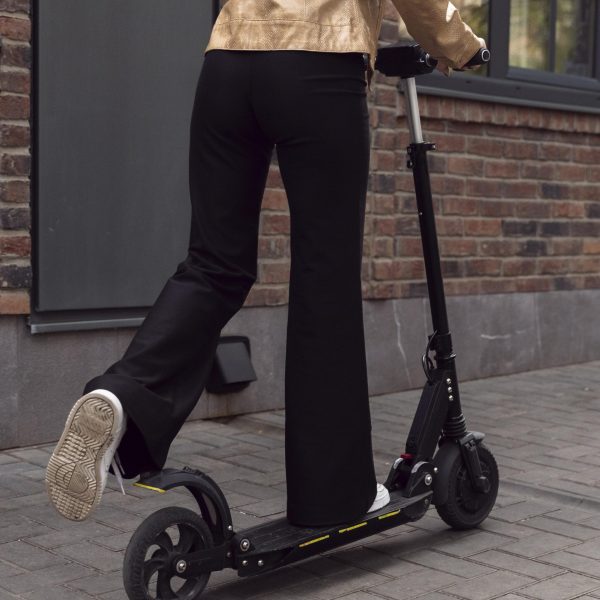 back-view-woman-riding-electric-scooter-outdoors back-view-woman-riding-electric-scooter-outdoors